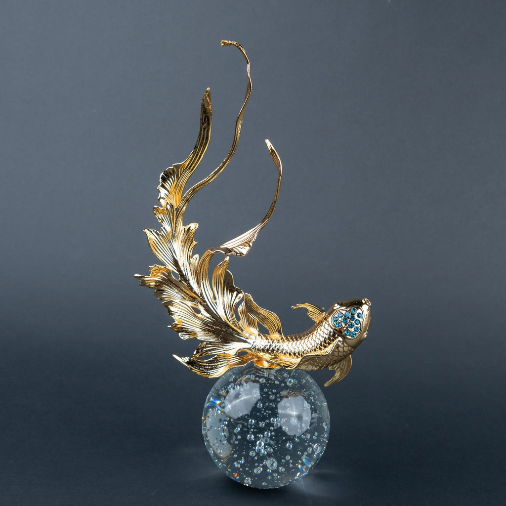 Luxury gold fish showpiece featuring detailed scales, blue embellishments and clear base.