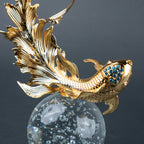 Luxury gold fish showpiece featuring detailed scales, blue embellishments and clear base.