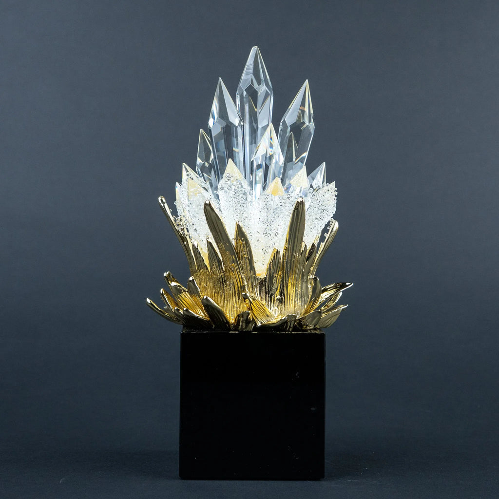 Close-up of gold-tone detailing and clear crystal-like peaks on the larger decorative piece