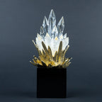Close-up of gold-tone detailing and clear crystal-like peaks on the larger decorative piece