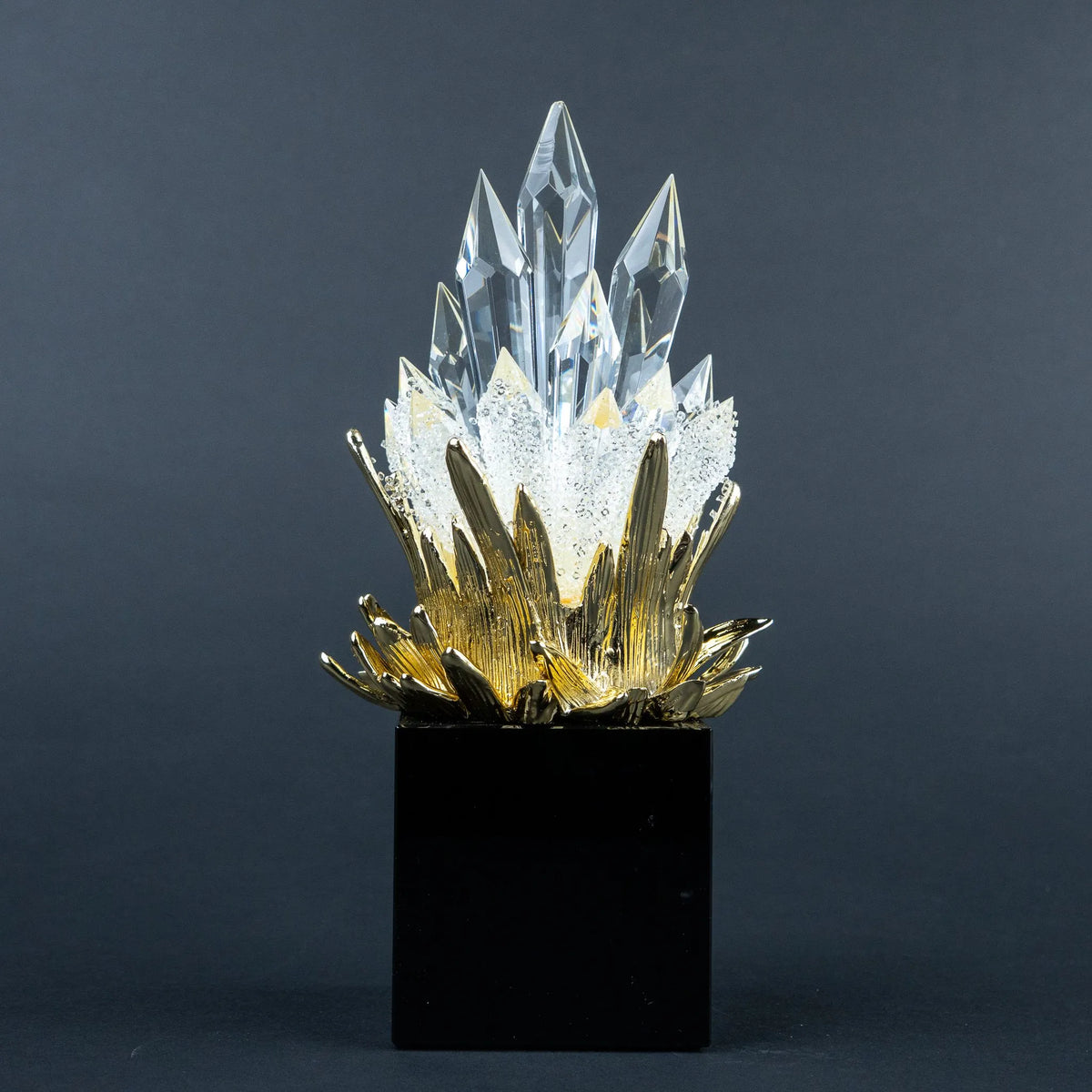 Close-up of gold-tone detailing and clear crystal-like peaks on the larger decorative piece