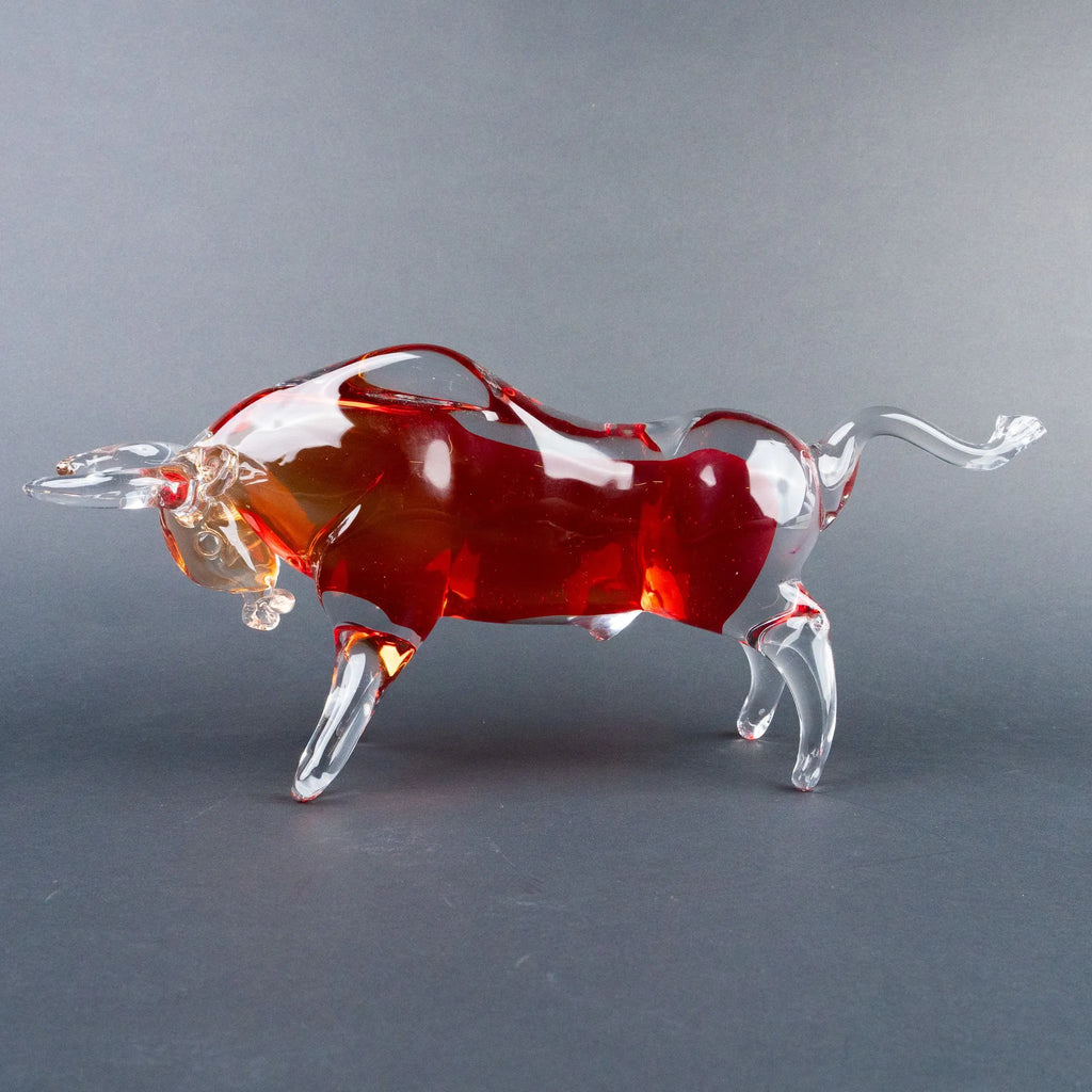 Decorative bull figurine featuring rich red, amber and clear tones