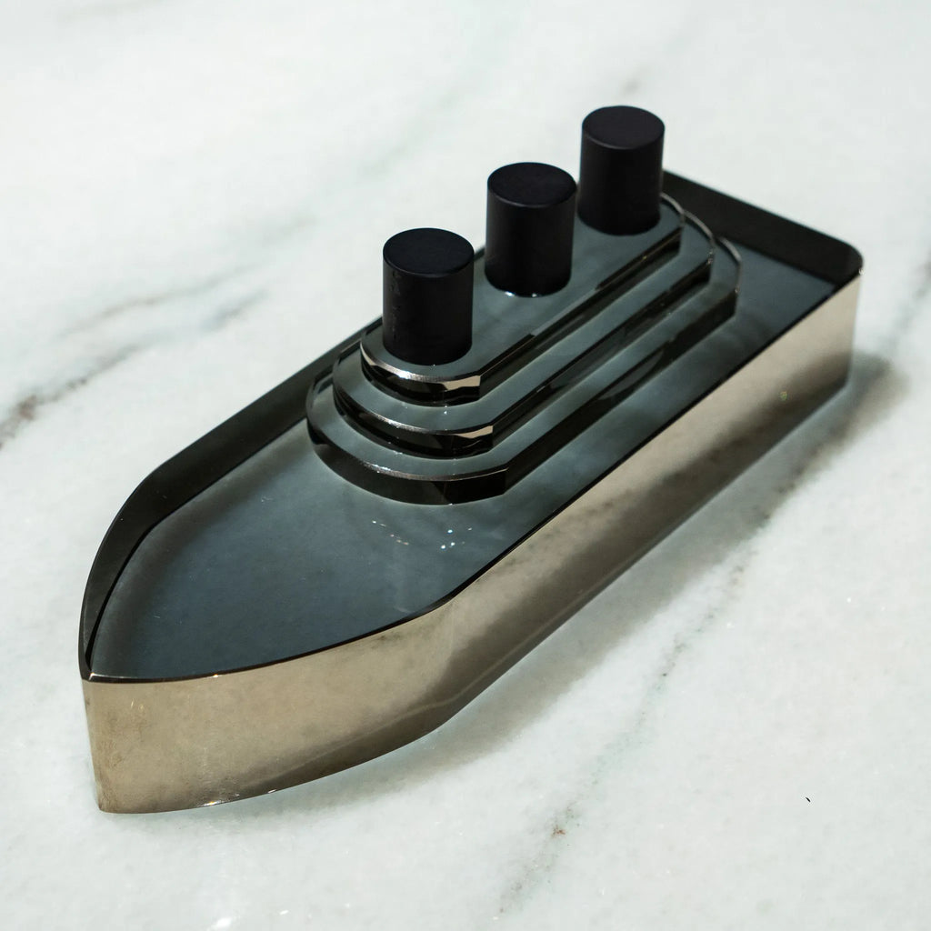 Decorative smoky glass ship with three black cylindrical details