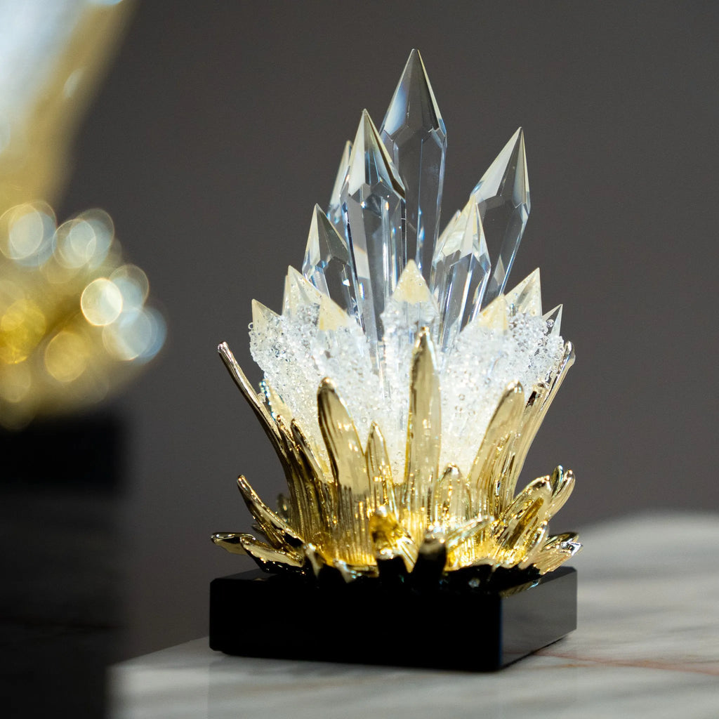 Large and small flame-inspired decorative accents displayed together on a marble surface