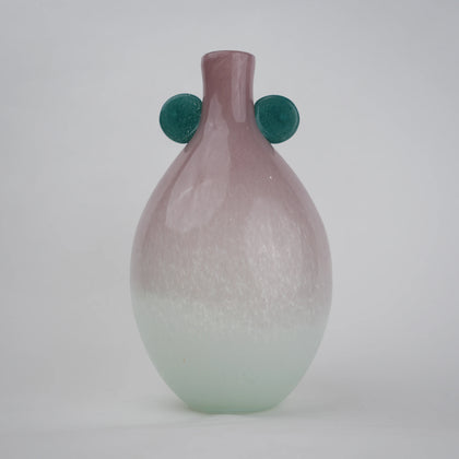 Vase with textured surface and green circular accents