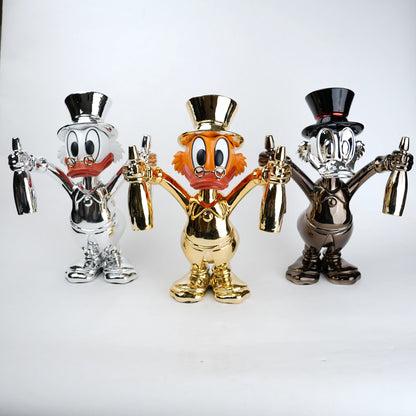 Three metallic figurines of a cartoon character with top hats on a white background