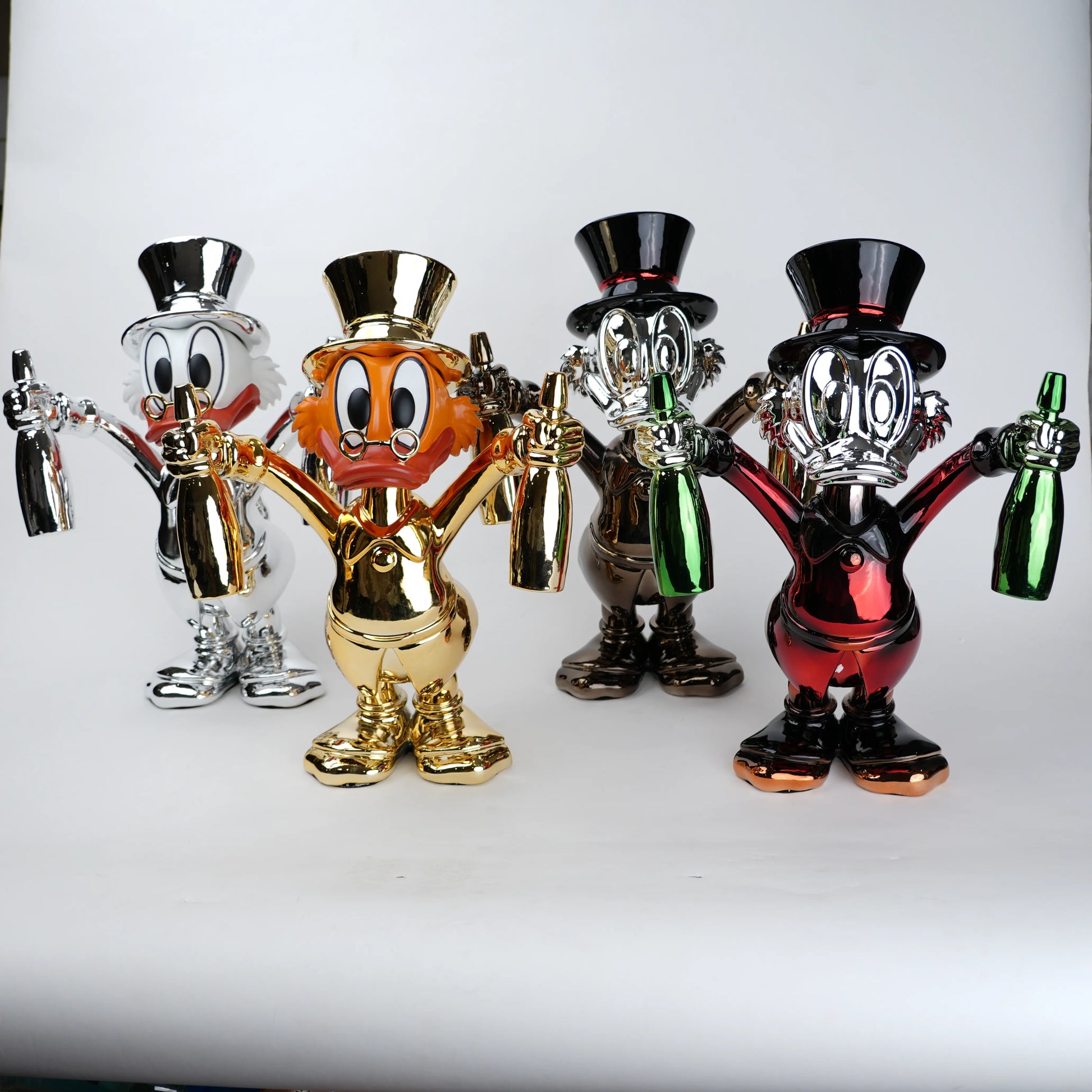 Four colorful figurines with top hats and bottles on a white background