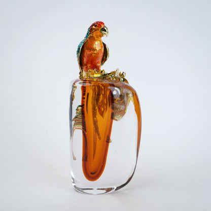 Modern decorative vase with colorful bird design and warm amber glass center