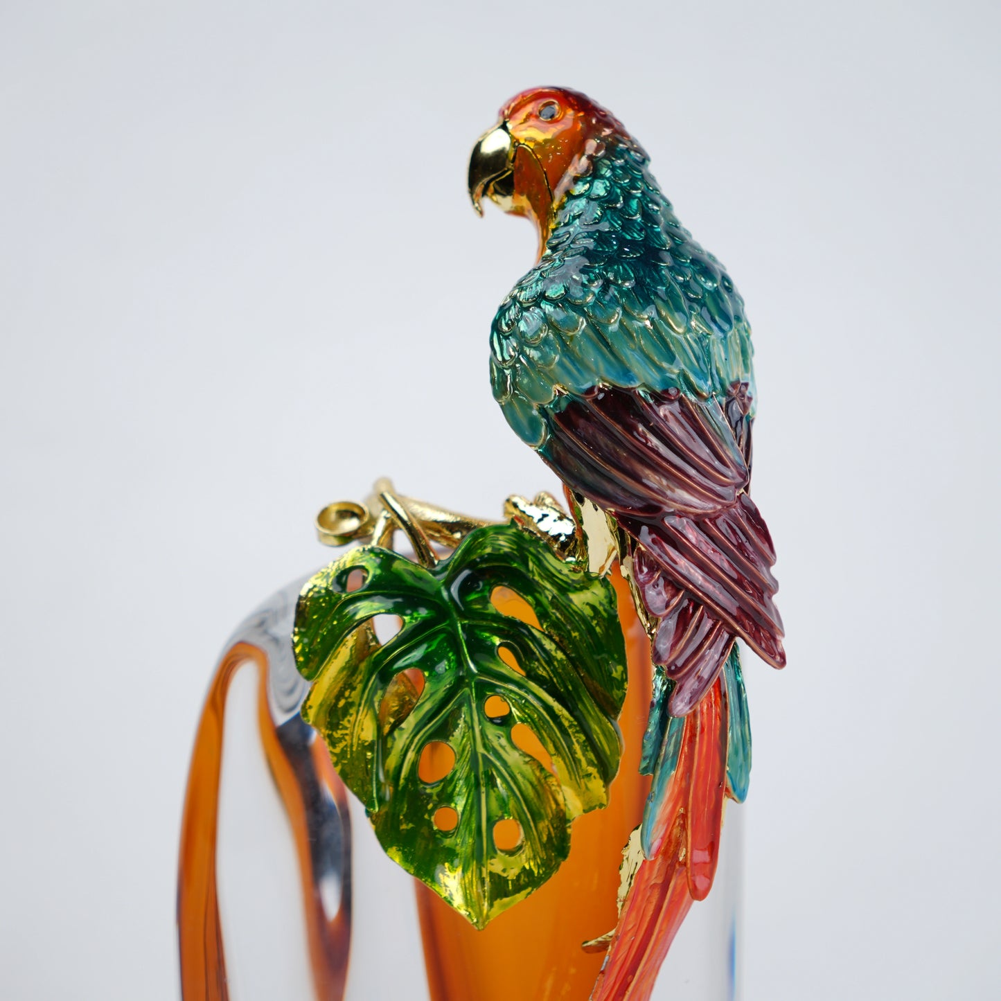 Artistic glass vase with parrot detail and transparent body for table decor