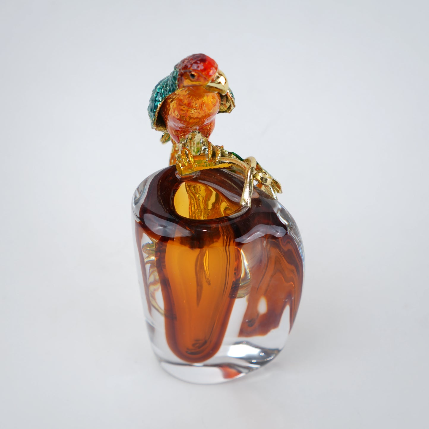 Clear glass vase featuring colorful parrot accent with green and orange tones for modern decor
