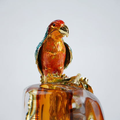 Modern decorative vase with colorful bird design and warm amber glass center