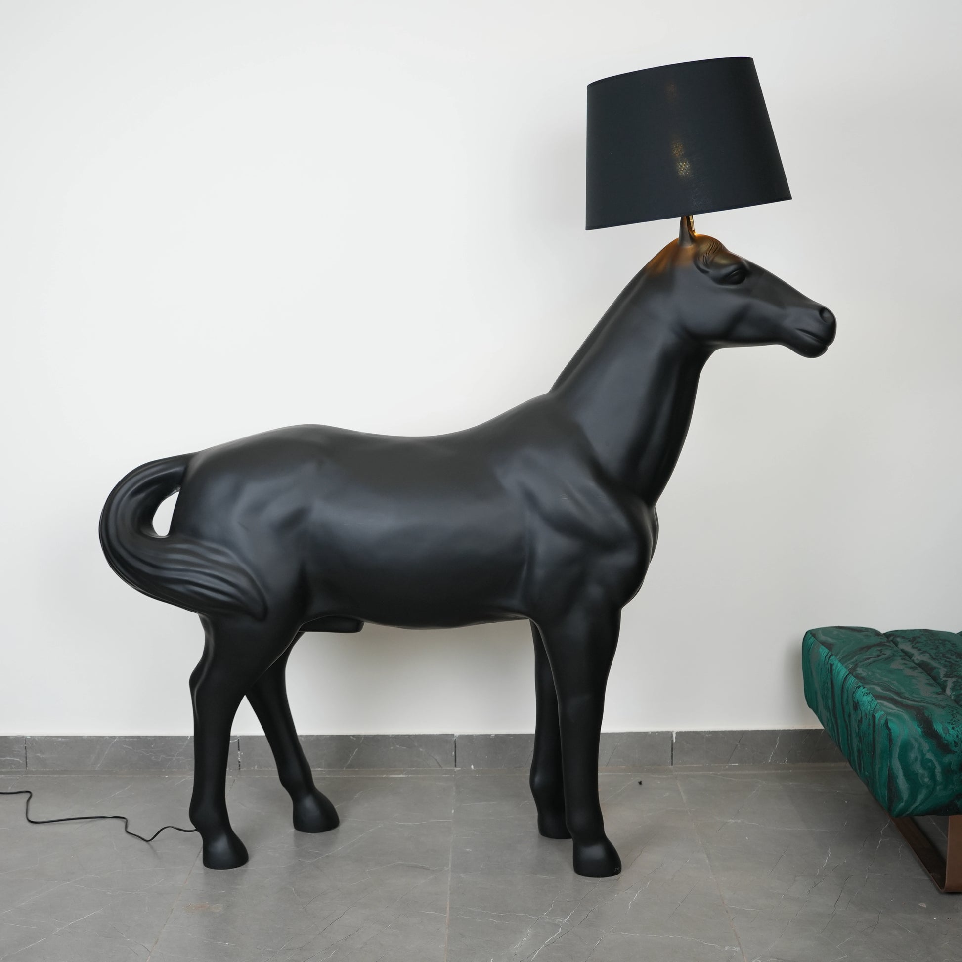 Black horse-shaped lamp in a room with a neutral color scheme.