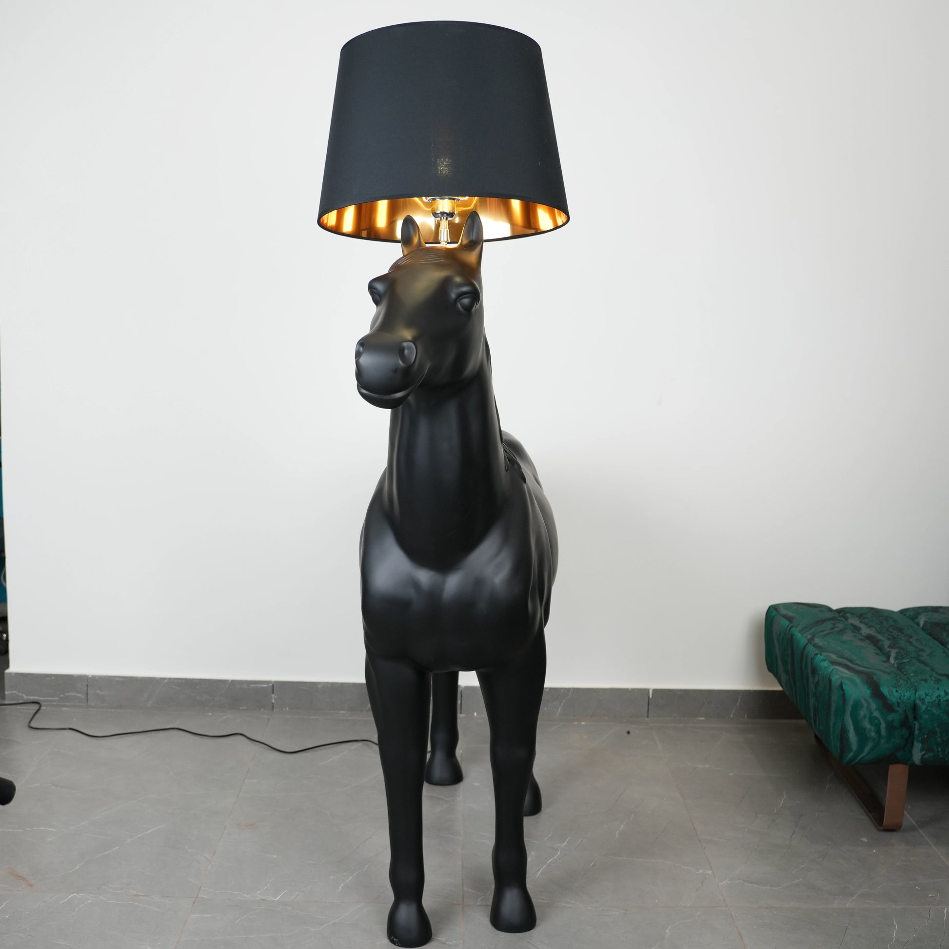 Black horse-shaped lamp in a room with a neutral color scheme.