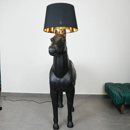 Black horse-shaped lamp in a room with a neutral color scheme.