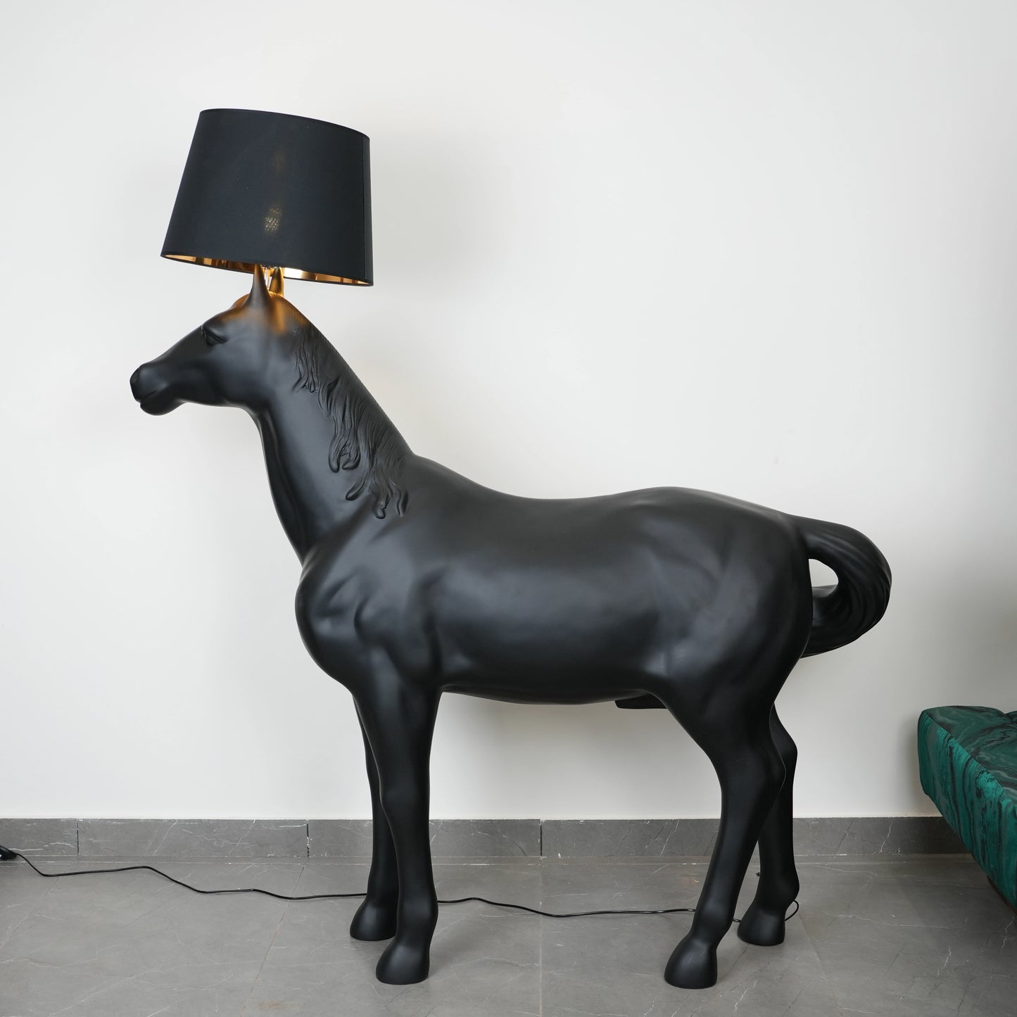 Black horse-shaped lamp in a room with a neutral color scheme.
