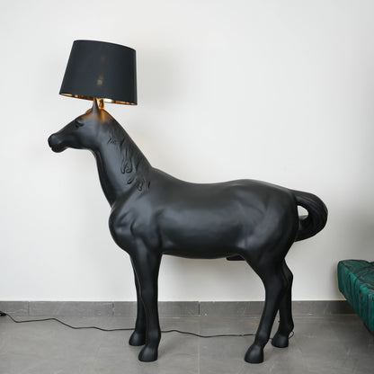 Black horse-shaped lamp in a room with a neutral color scheme.