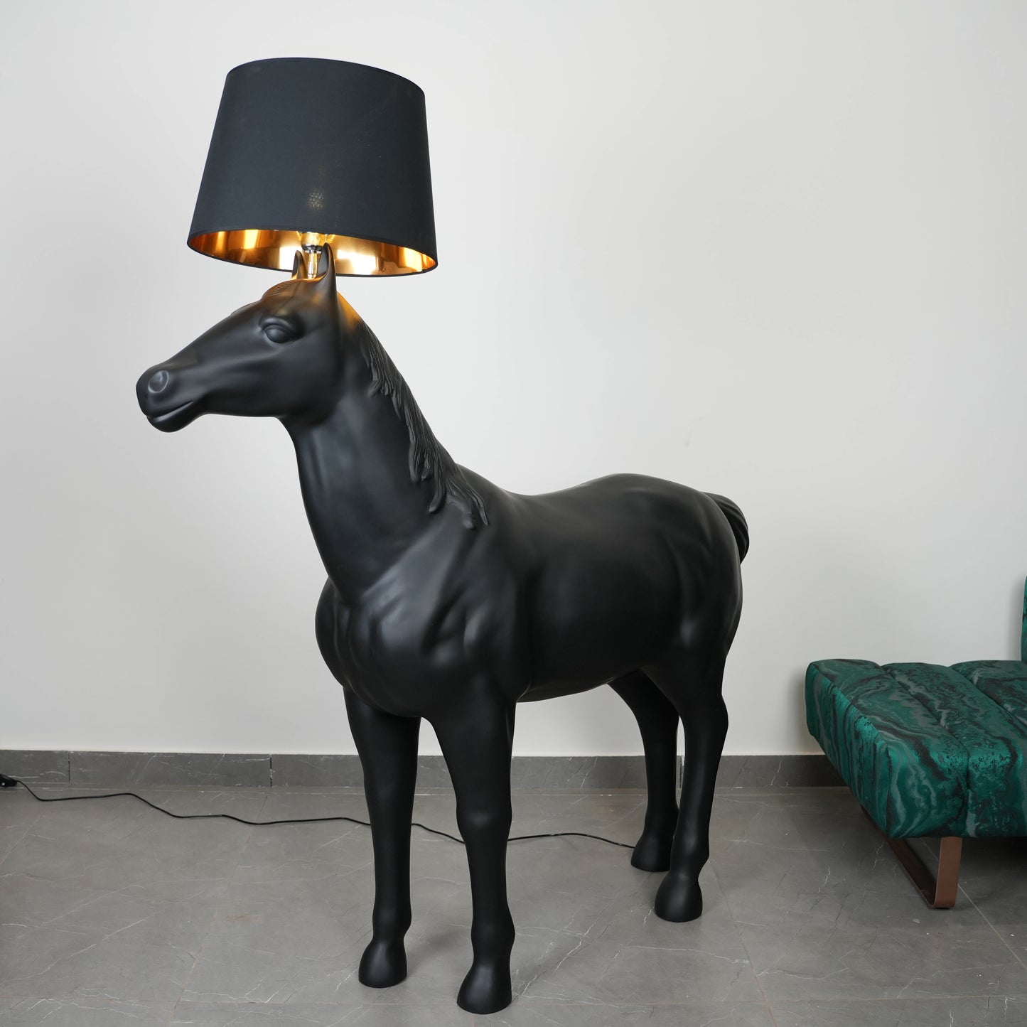 Black horse-shaped lamp in a room with a neutral color scheme.