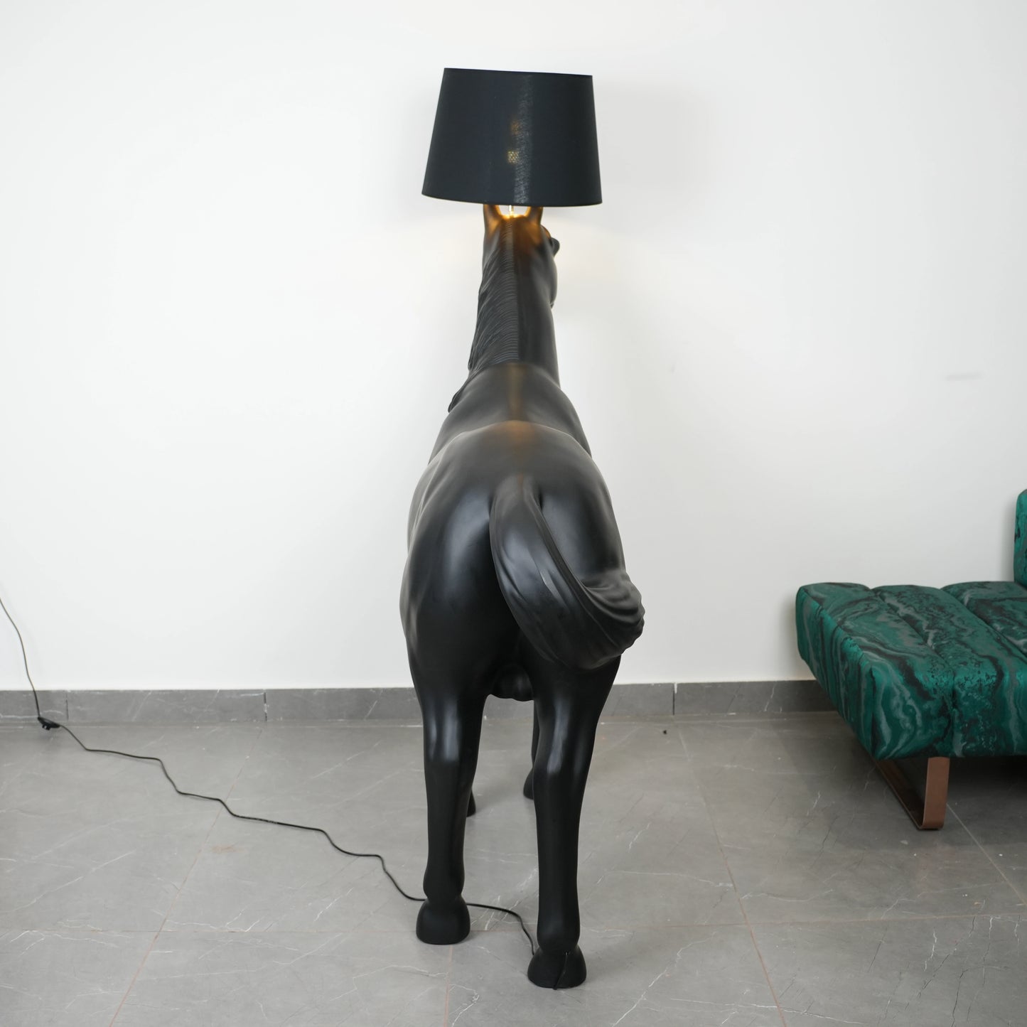 Black horse-shaped lamp in a room with a neutral color scheme.