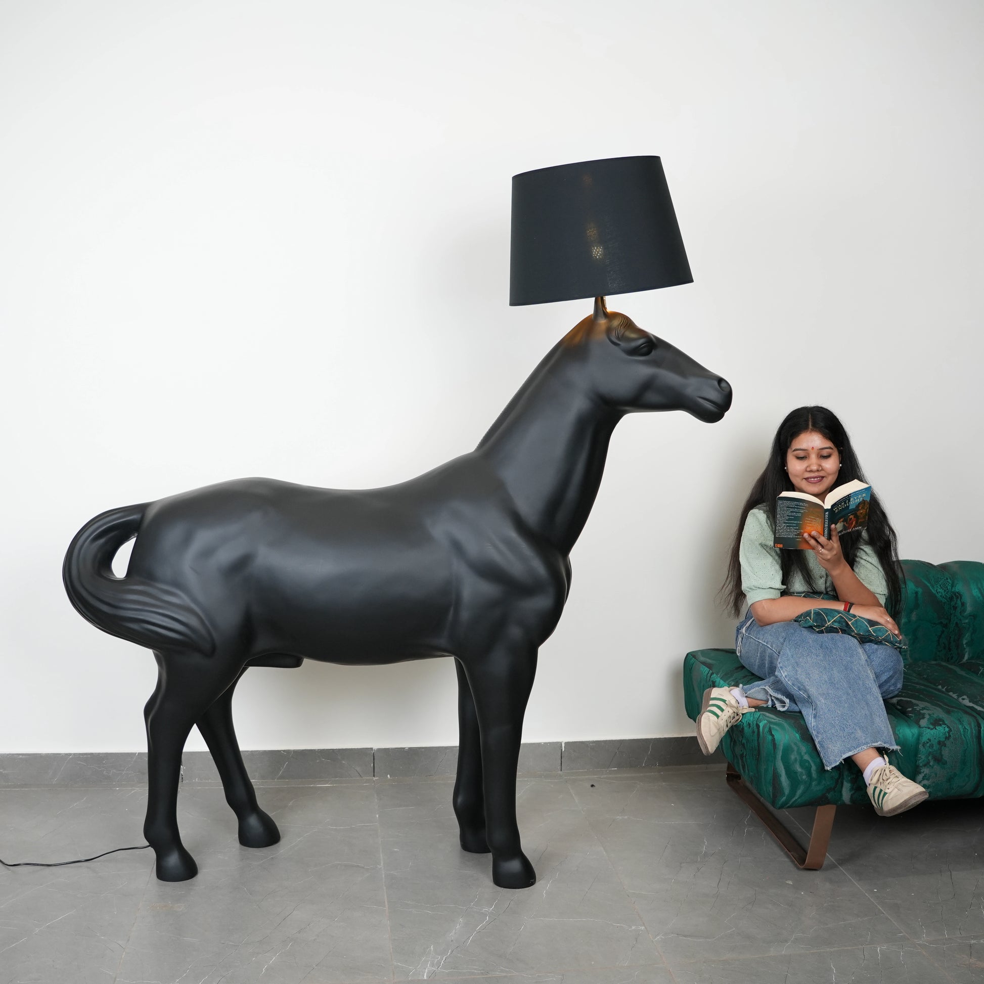 Black horse-shaped lamp in a room with a neutral color scheme.