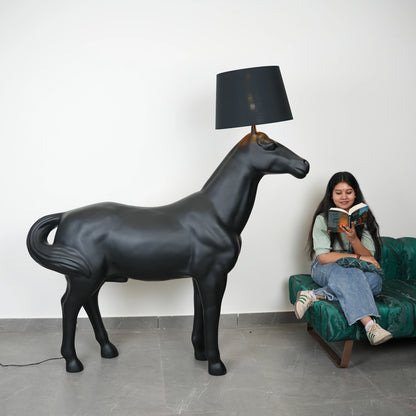 Black horse-shaped lamp in a room with a neutral color scheme.