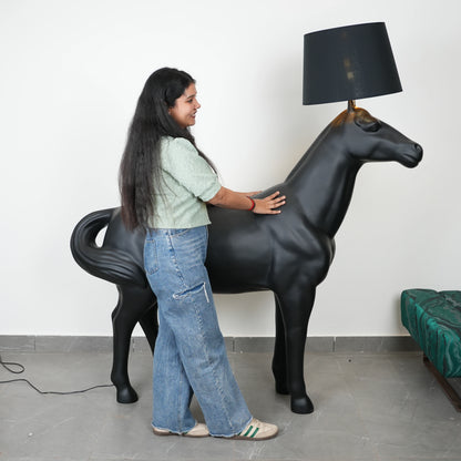 Black horse-shaped lamp in a room with a neutral color scheme.