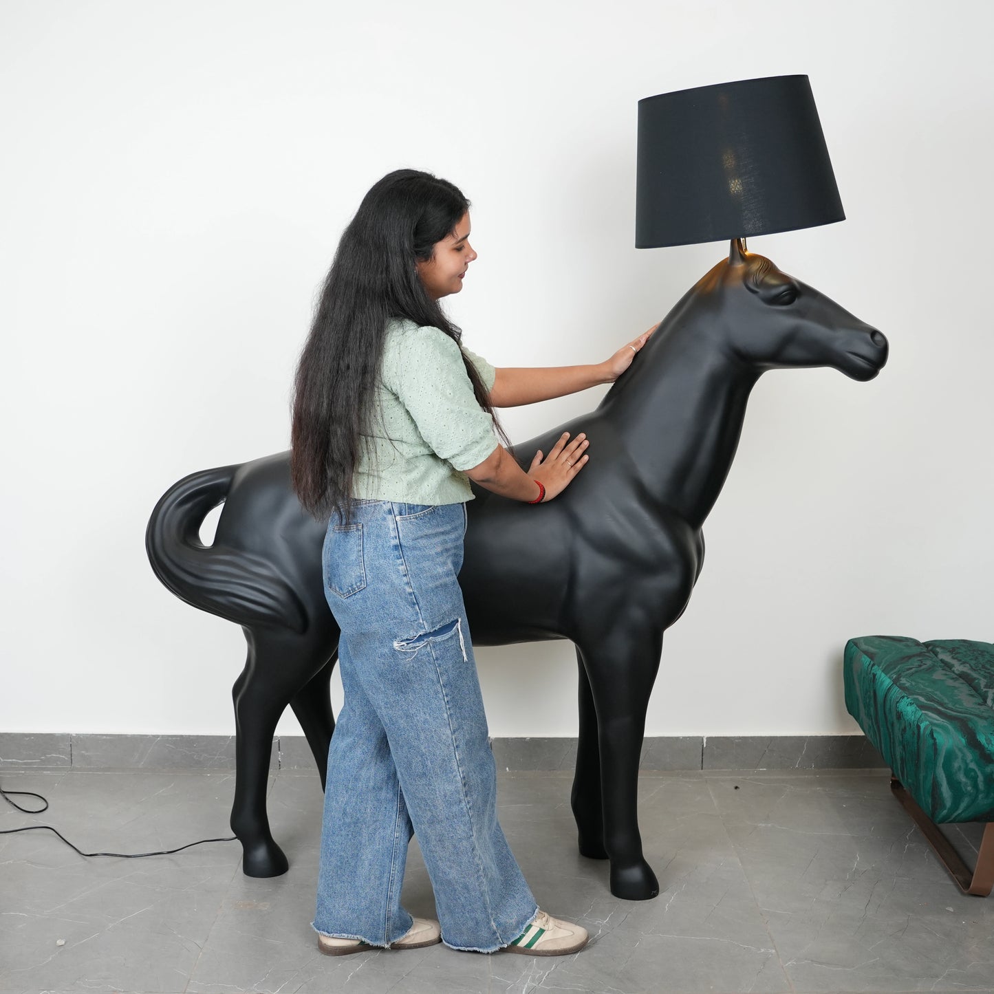 Black horse-shaped lamp in a room with a neutral color scheme.