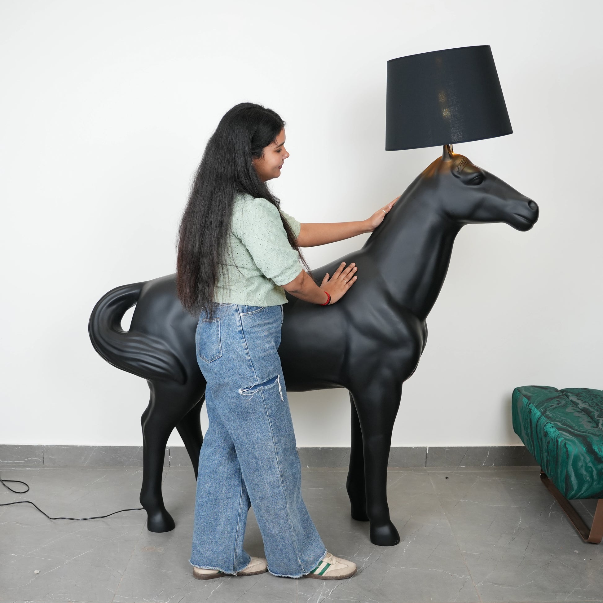 Black horse-shaped lamp in a room with a neutral color scheme.