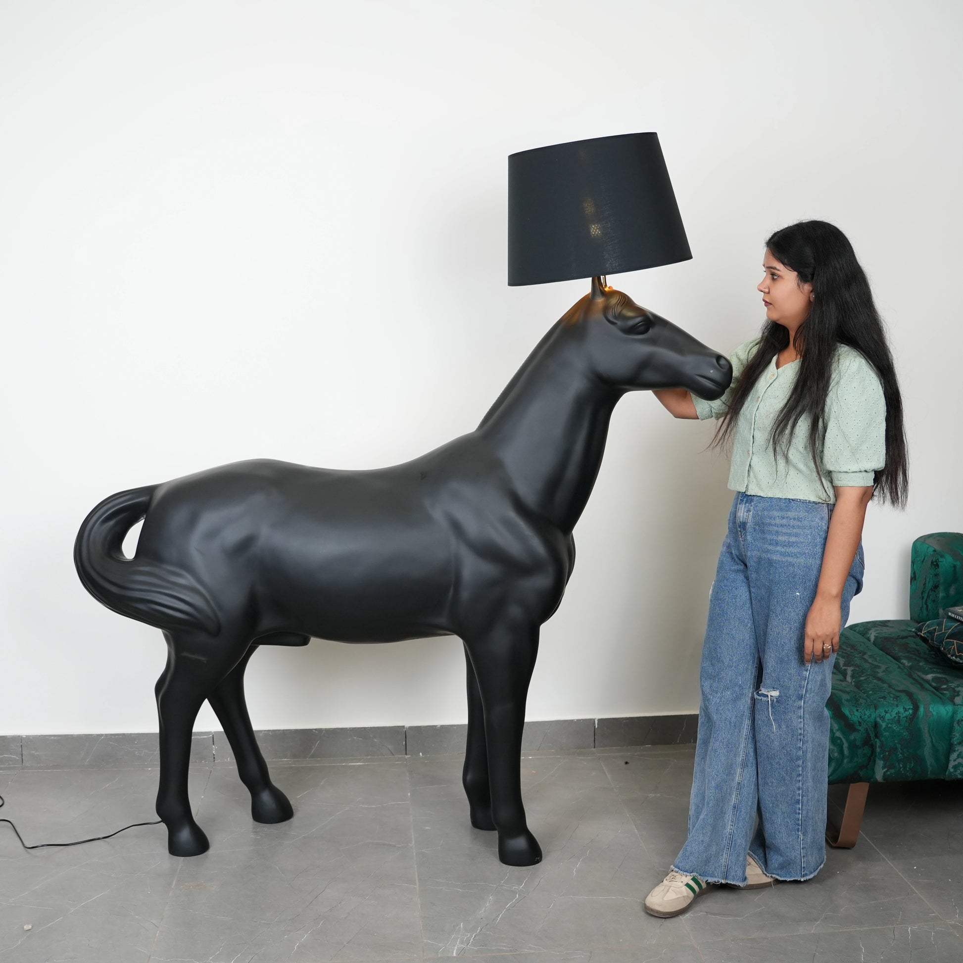 Black horse-shaped lamp in a room with a neutral color scheme.