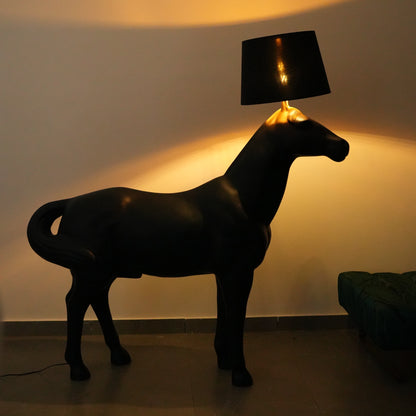 Black horse-shaped lamp in a room with a neutral color scheme.