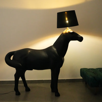 Black horse-shaped lamp in a room with a neutral color scheme.