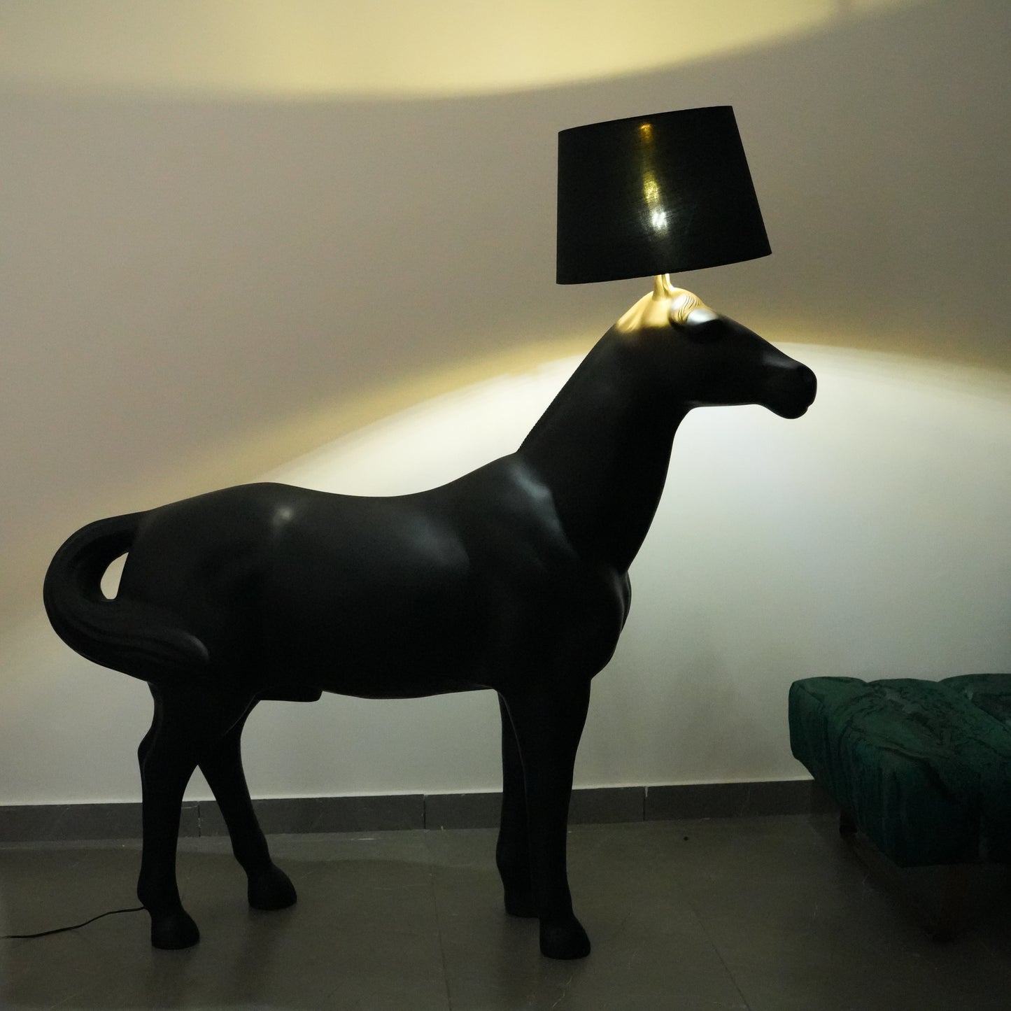 Black horse-shaped lamp in a room with a neutral color scheme.