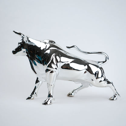 Silver bull sculpture on a light gray background