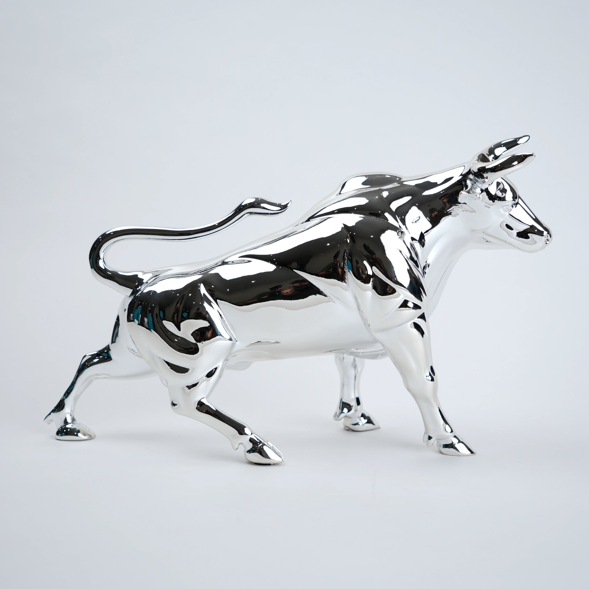 Chrome bull statue on a white background