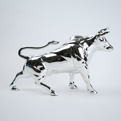 Chrome bull statue on a white background
