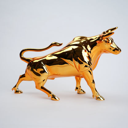 Gold bull figurine on a light gray background