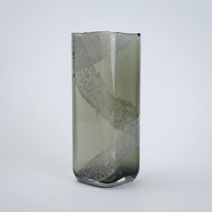 Decorative glass vase with textured surface on a white background
