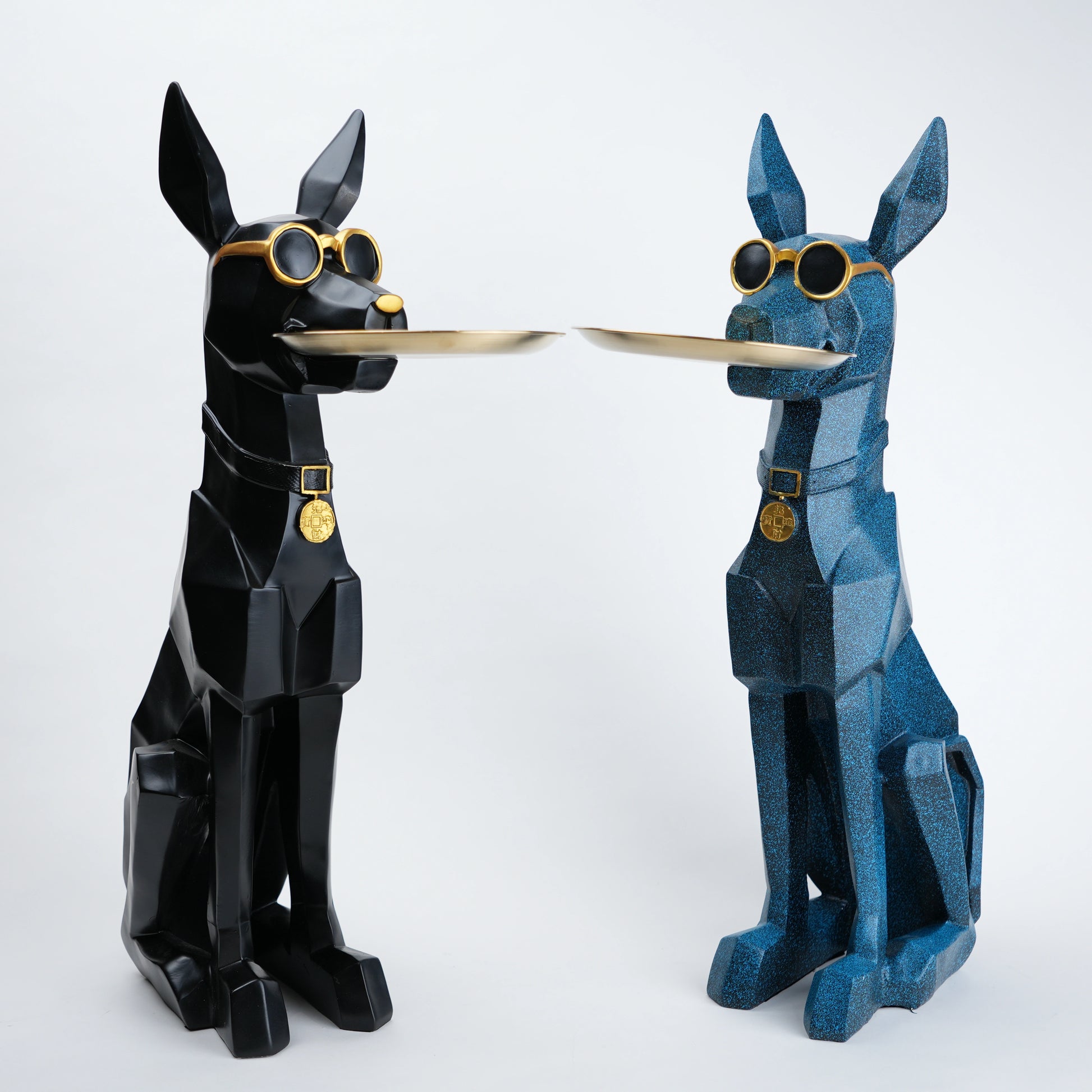 Two stylized dog figures, one black and one blue, holding a tray on a white background.