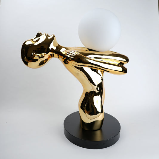 gold sculptural table lamp with frosted globe modern decor
