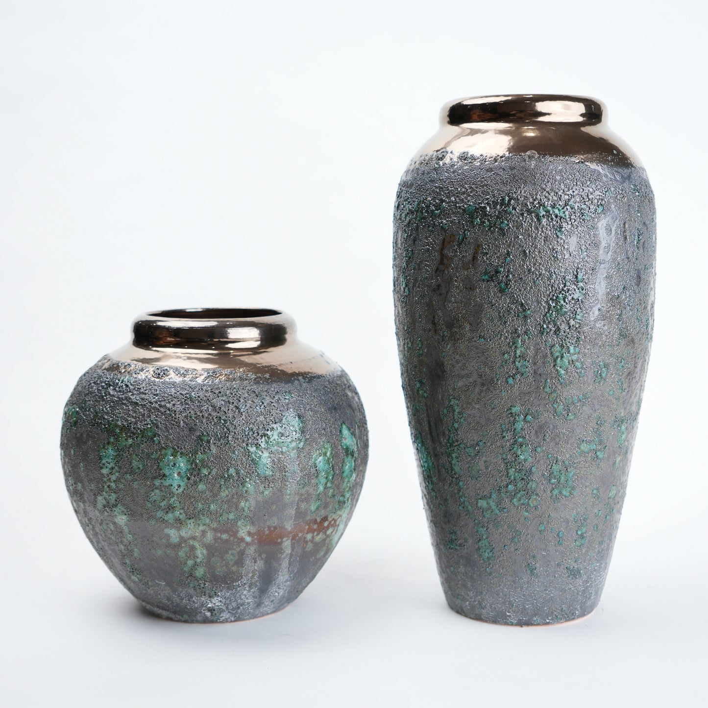 green charcoal ceramic vase with patina texture and bronze neck
