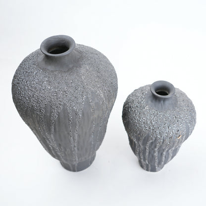 Two gray textured vases on a white background
