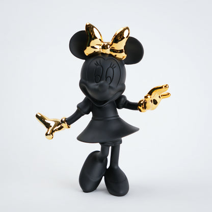 Black and gold character figurine on a white background