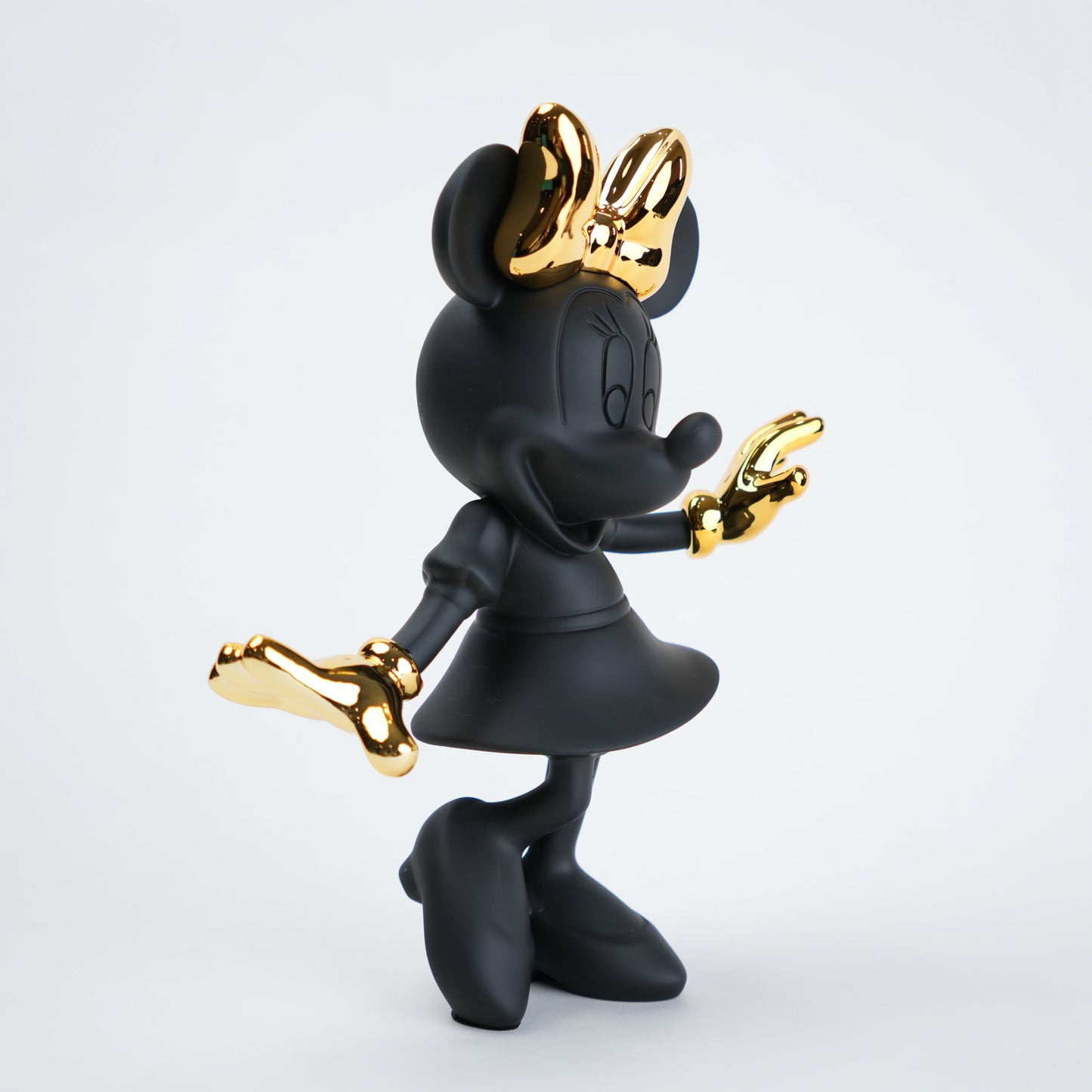 Black and gold character figurine on a white background