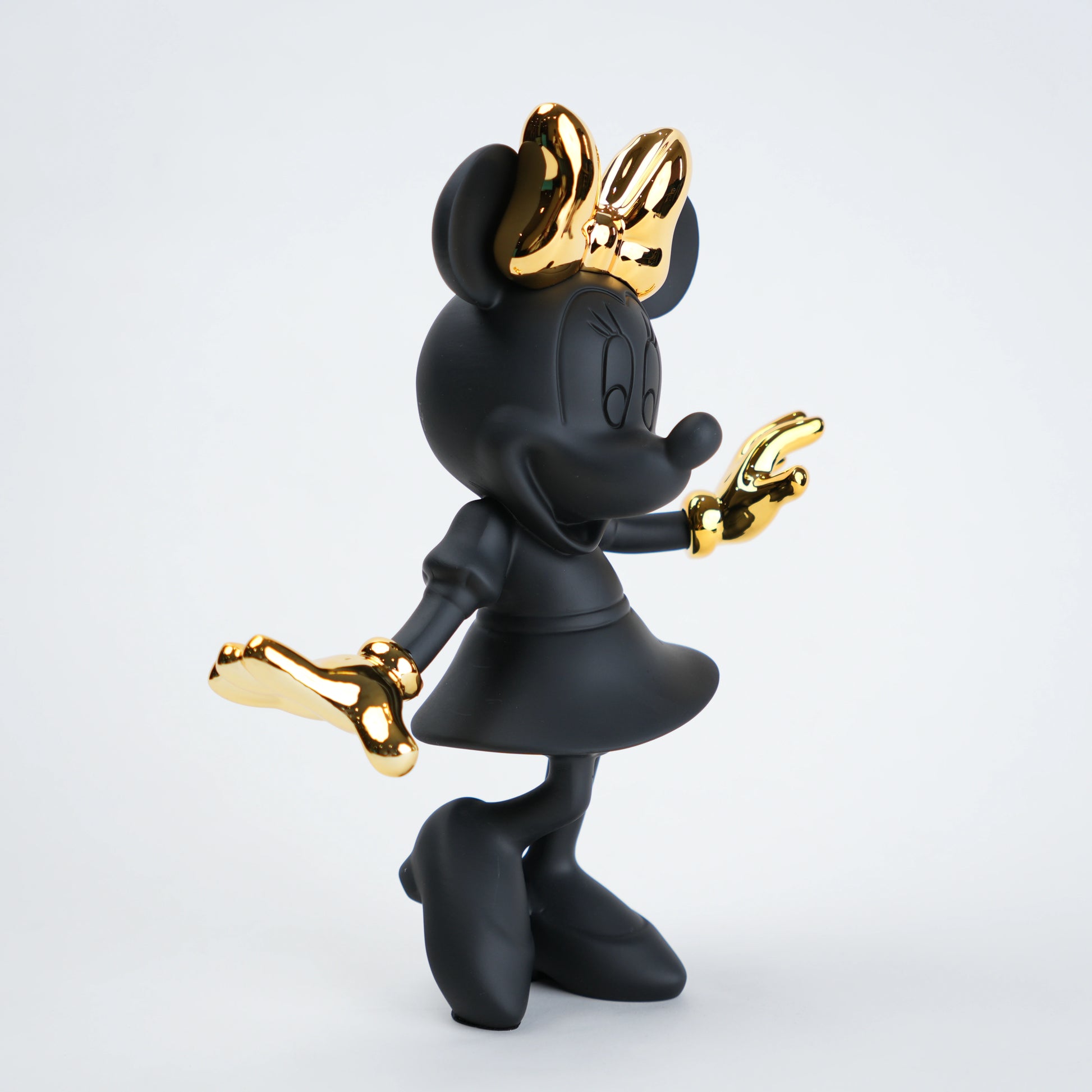 Black and gold character figurine on a white background