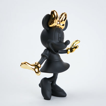 Black and gold character figurine on a white background