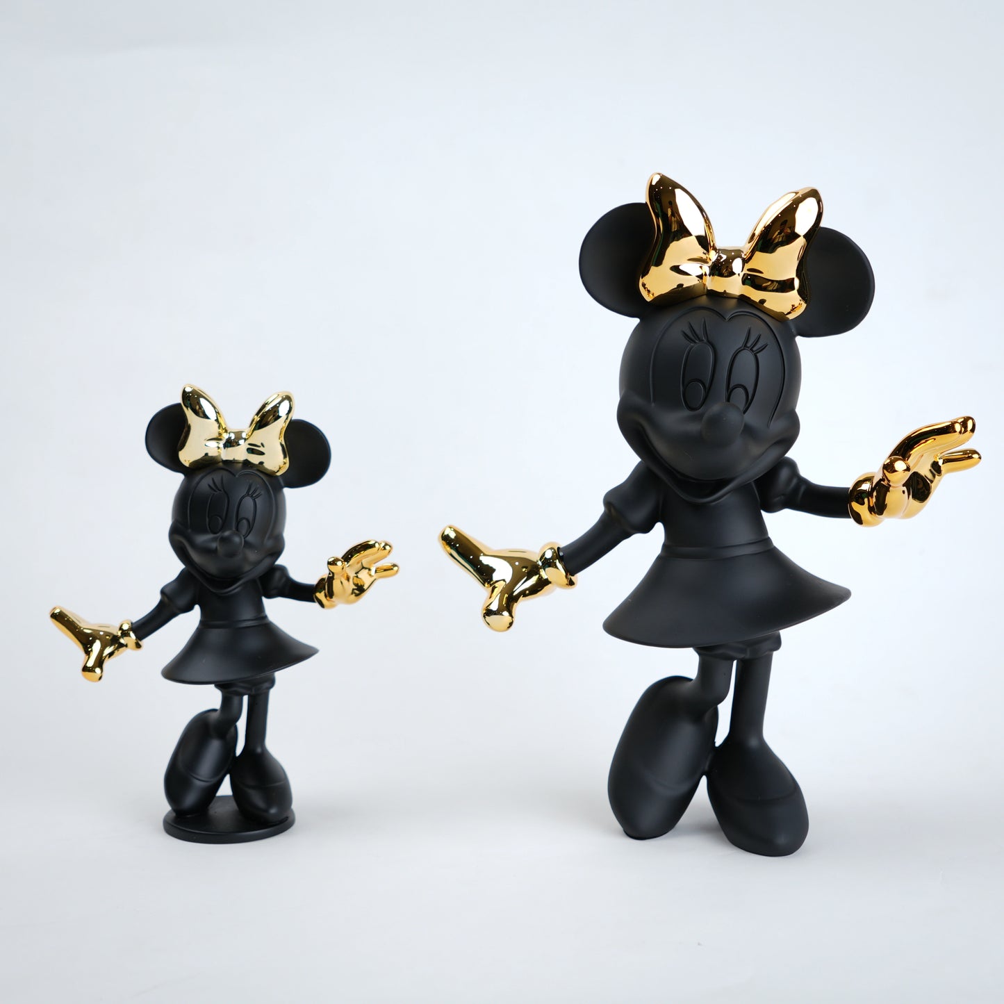 Black and gold Minnie Mouse figurine on a white background