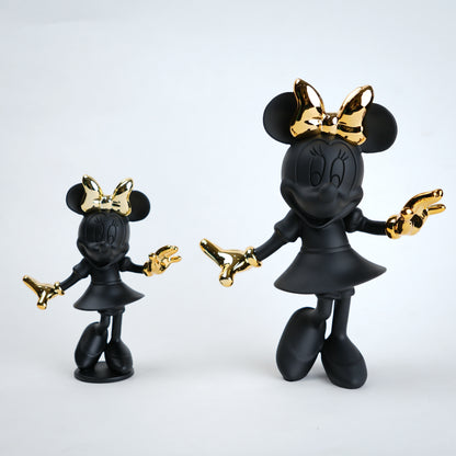 Black and gold Minnie Mouse figurine on a white background