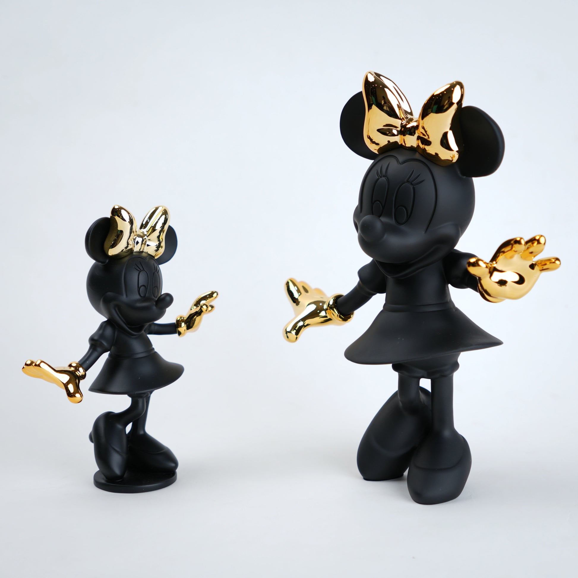 Black and gold Minnie Mouse figurine on a white background