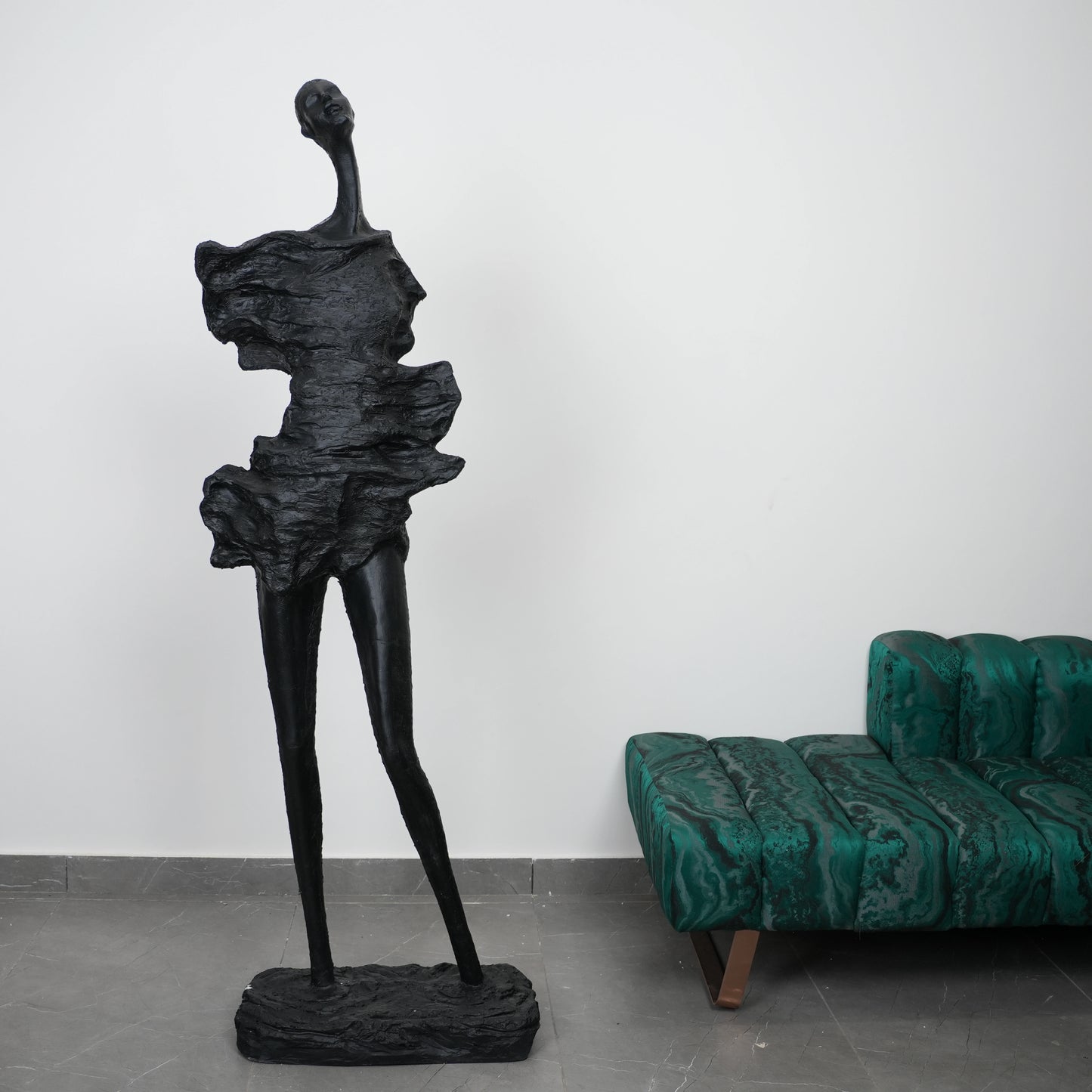 tall black sculpture human form living room statement piece