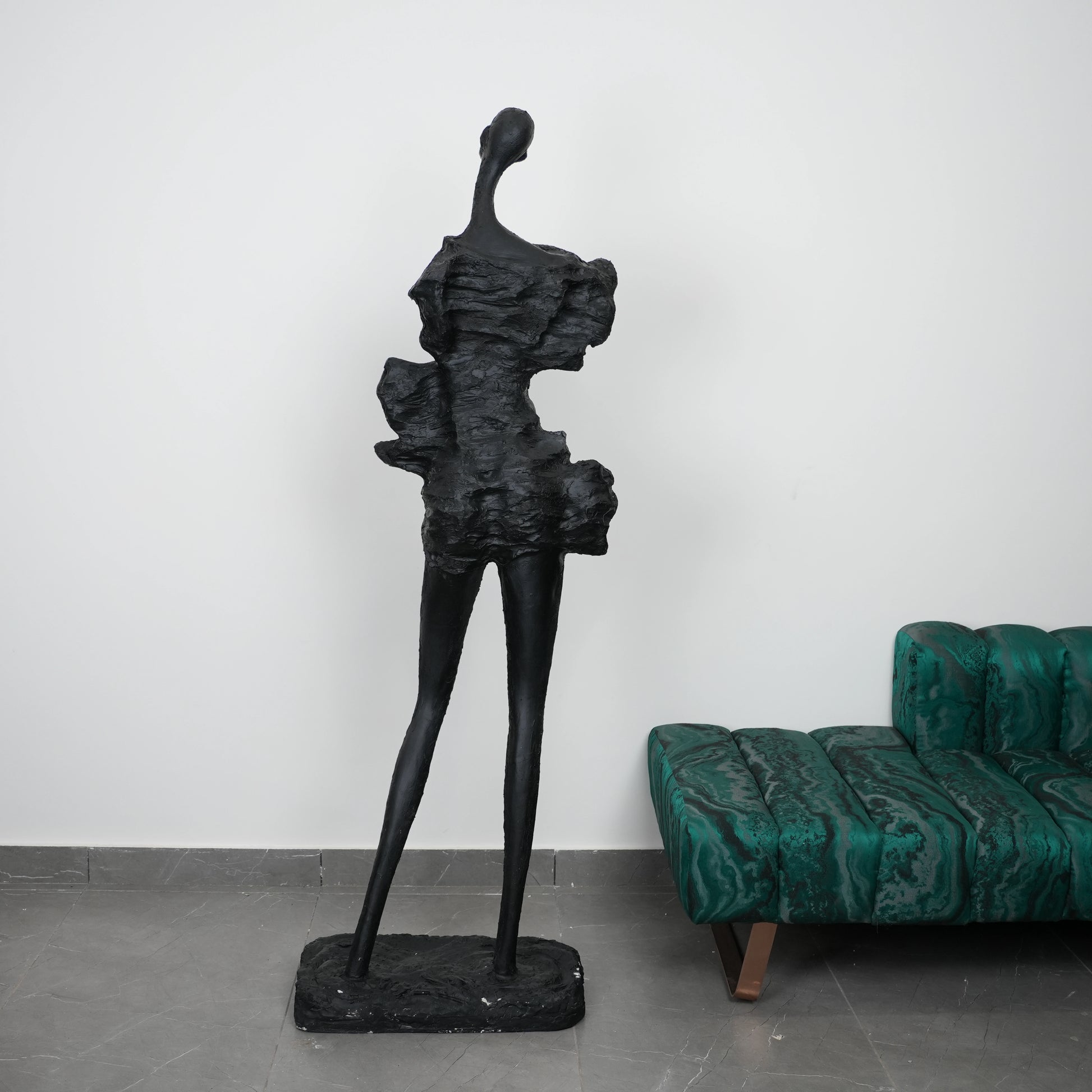 Abstract human sculpt by emerald malachite sofa
