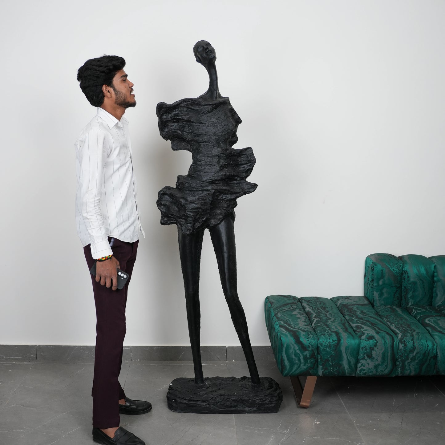 Abstract human sculpt, scale beside man, gallery